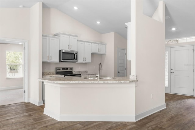 39 Zaun Trl, Palm Coast, FL 32164 - kitchen featuring stainless steel appliances, a sink, baseboards, dark wood-type flooring, and white cabinets