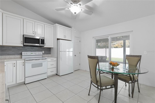 kitchen with white appliances, vaulted ceiling, decorative backsplash, ceiling fan, and white cabinetry