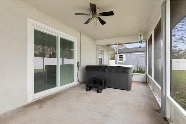 sunroom featuring a jacuzzi and ceiling fan