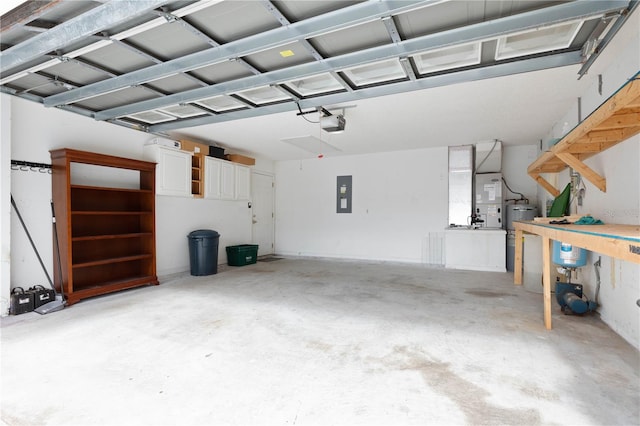 garage featuring a workshop area, electric water heater, a garage door opener, electric panel, and heating unit