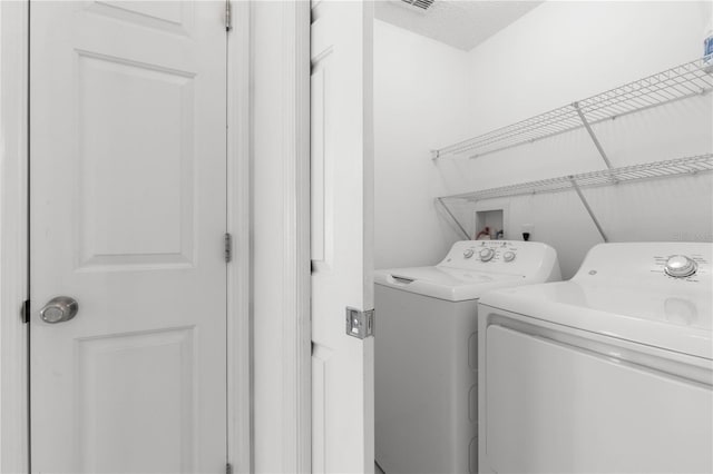 laundry room featuring washer and clothes dryer