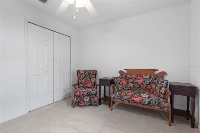 sitting room with light colored carpet and ceiling fan