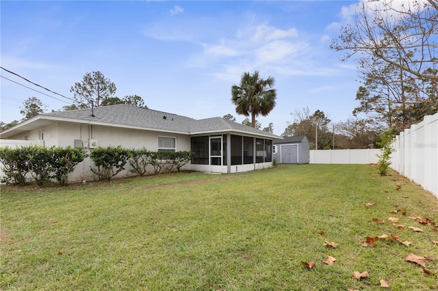 back of property with a yard and a storage unit