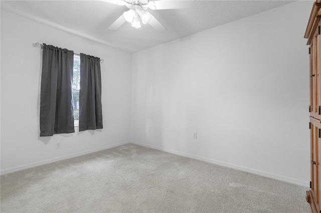 empty room featuring light carpet and ceiling fan