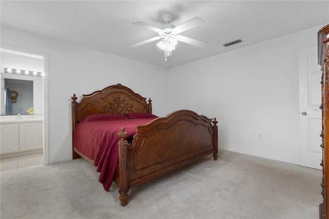 carpeted bedroom featuring connected bathroom, ceiling fan, and sink