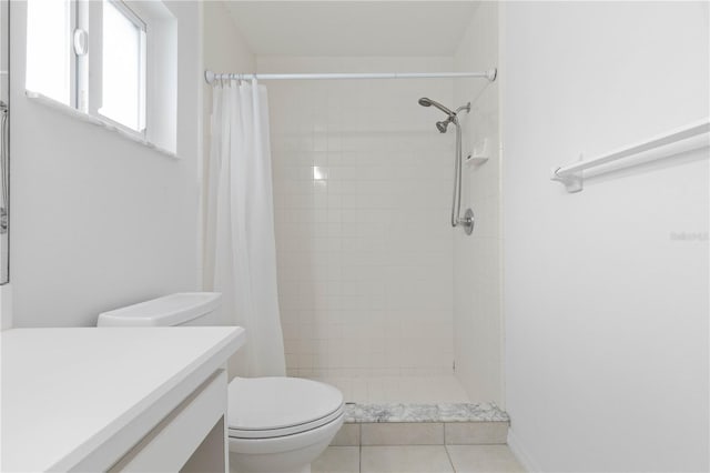 bathroom with a shower with shower curtain, tile patterned flooring, toilet, and vanity