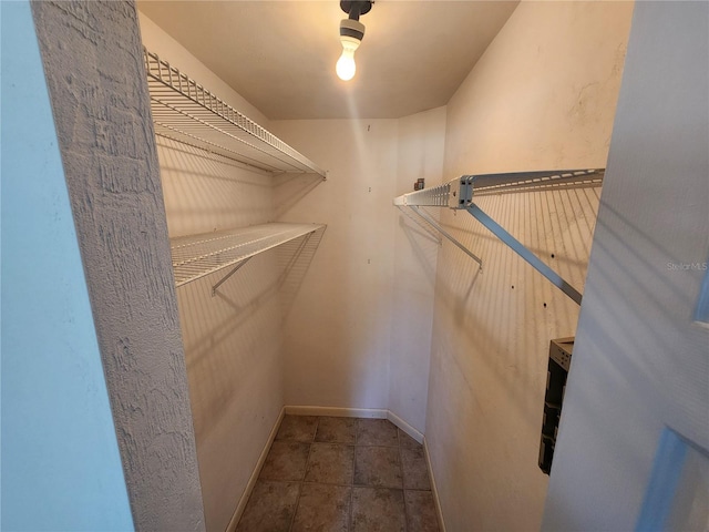 spacious closet with tile patterned floors