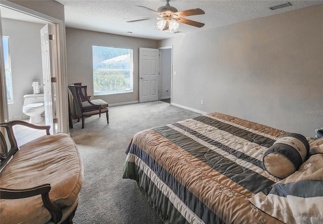 bedroom featuring carpet floors, visible vents, ceiling fan, a textured ceiling, and baseboards