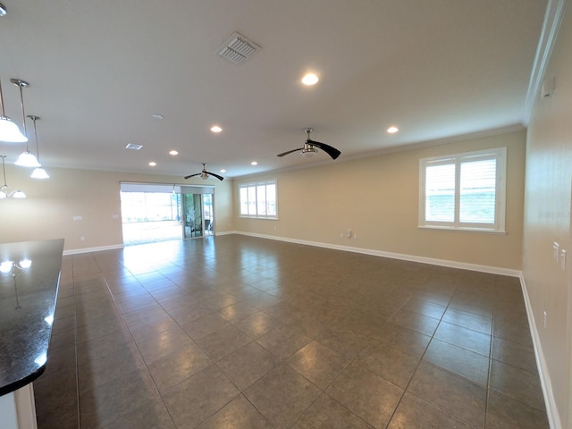 tiled empty room with ceiling fan and ornamental molding