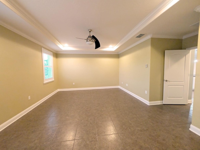 unfurnished room with a tray ceiling and crown molding