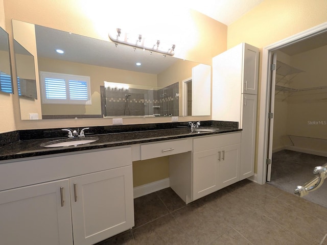 bathroom featuring vanity, tile patterned floors, and walk in shower