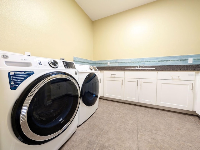 laundry area featuring sink, light tile patterned flooring, cabinets, and independent washer and dryer