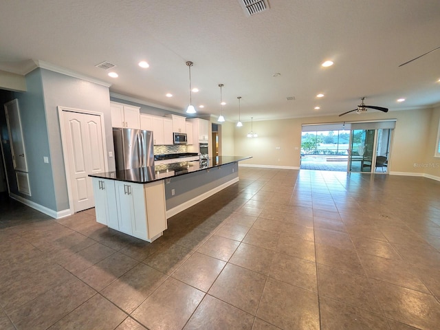 kitchen with ceiling fan, white cabinetry, hanging light fixtures, an island with sink, and appliances with stainless steel finishes