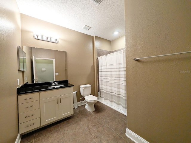 bathroom with curtained shower, vanity, a textured ceiling, and toilet