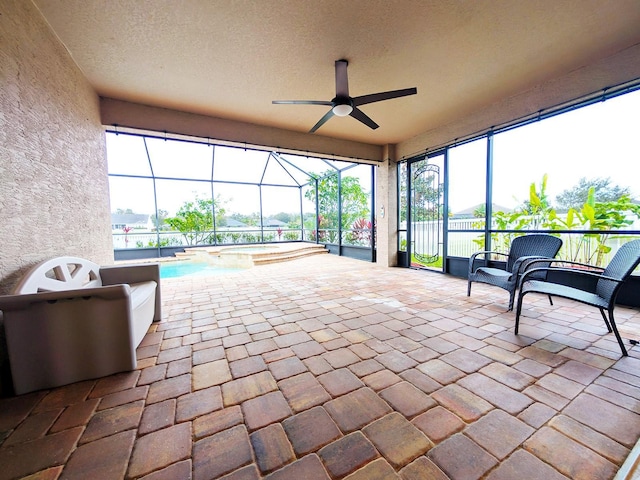 sunroom featuring ceiling fan