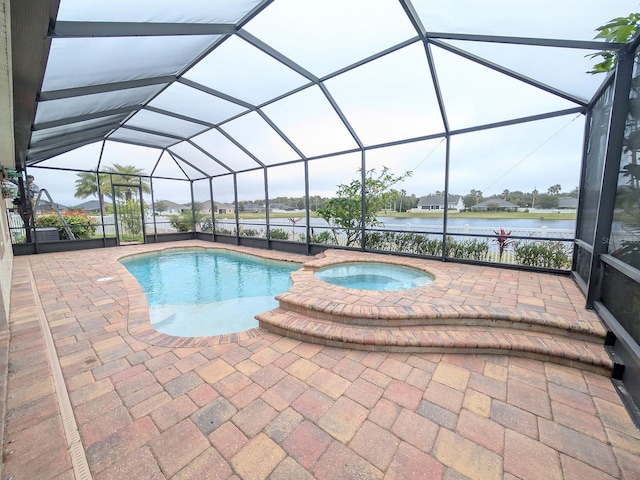 view of pool featuring glass enclosure, a water view, a patio, and an in ground hot tub