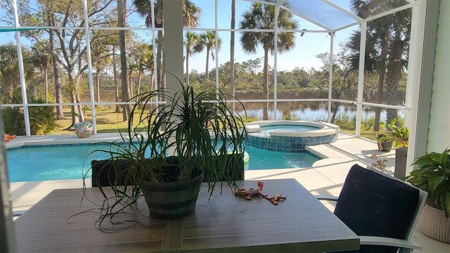 view of pool with a water view, a lanai, a patio, and an in ground hot tub