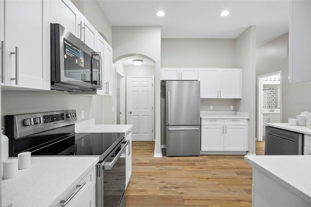 kitchen with white cabinetry, light hardwood / wood-style flooring, and appliances with stainless steel finishes