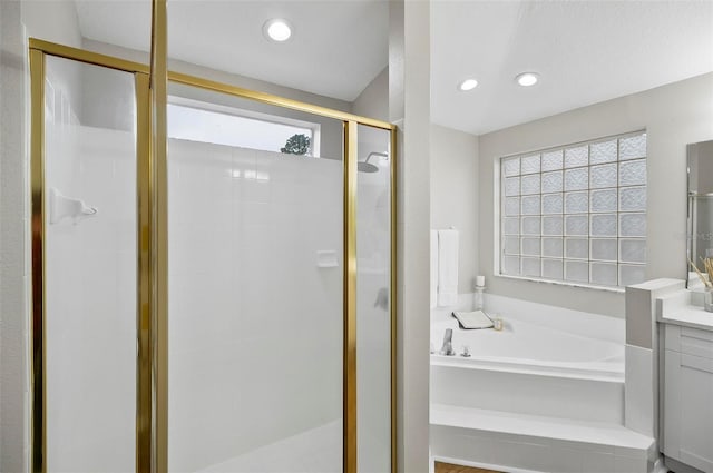 bathroom with vanity and plus walk in shower