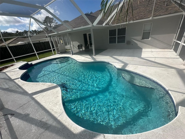 view of pool with a lanai and a patio