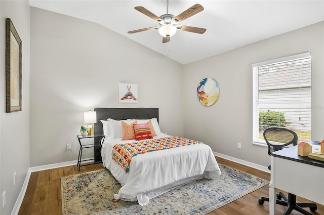 bedroom featuring ceiling fan, wood-type flooring, and lofted ceiling