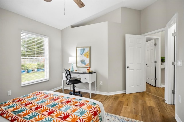 bedroom with hardwood / wood-style flooring, ceiling fan, and lofted ceiling