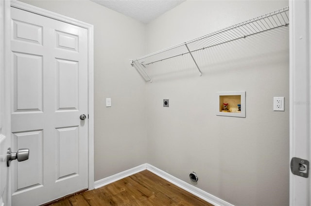 clothes washing area with wood-type flooring, washer hookup, and hookup for an electric dryer