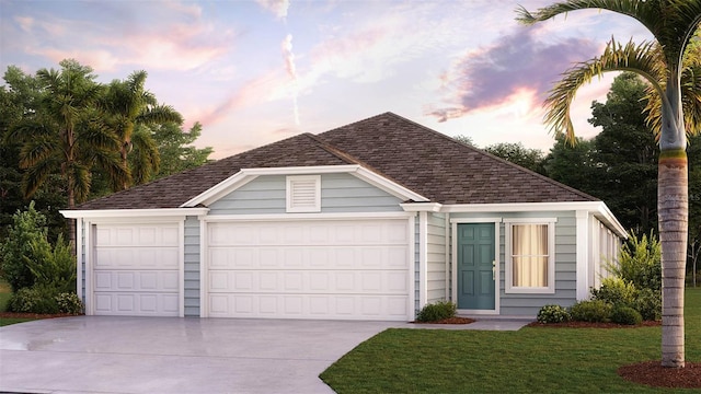 view of front of home with a garage and a yard