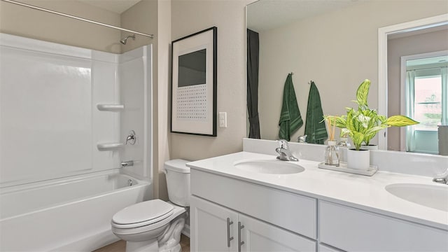 full bathroom featuring vanity, bathtub / shower combination, and toilet