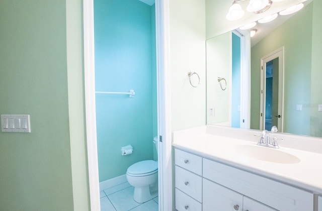 bathroom featuring tile patterned flooring, vanity, and toilet