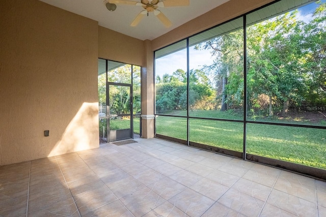 unfurnished sunroom with ceiling fan