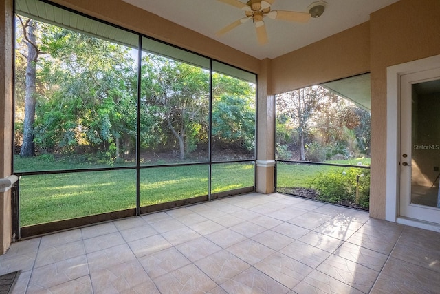 unfurnished sunroom featuring ceiling fan