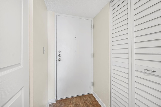 hallway with a textured ceiling