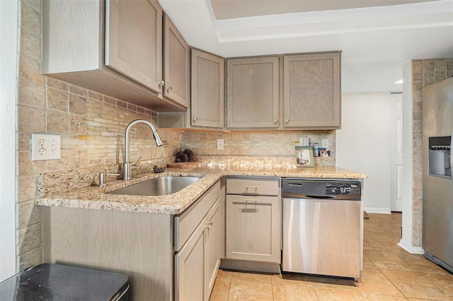 kitchen with backsplash, sink, light tile patterned floors, light stone counters, and stainless steel appliances