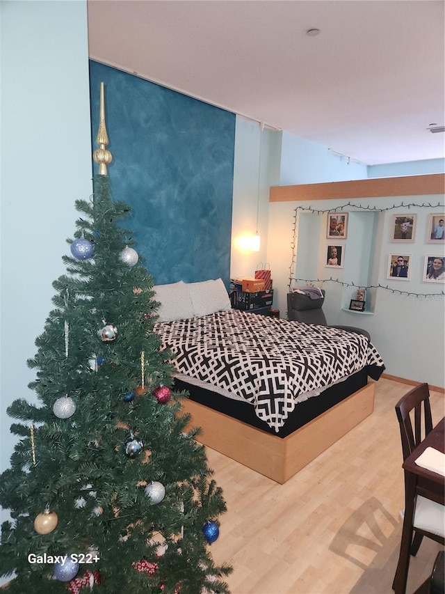 bedroom with hardwood / wood-style flooring