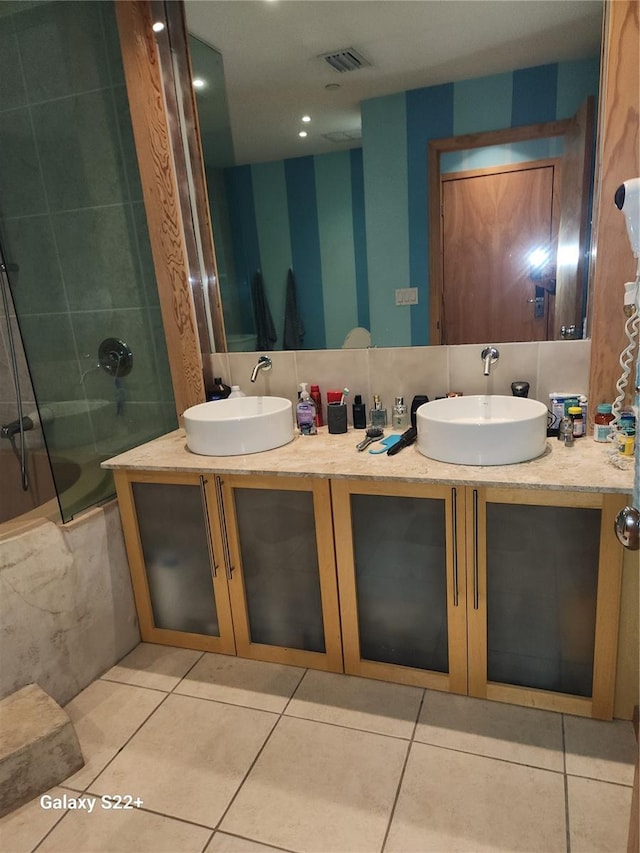 bathroom with bathtub / shower combination, vanity, and tile patterned flooring