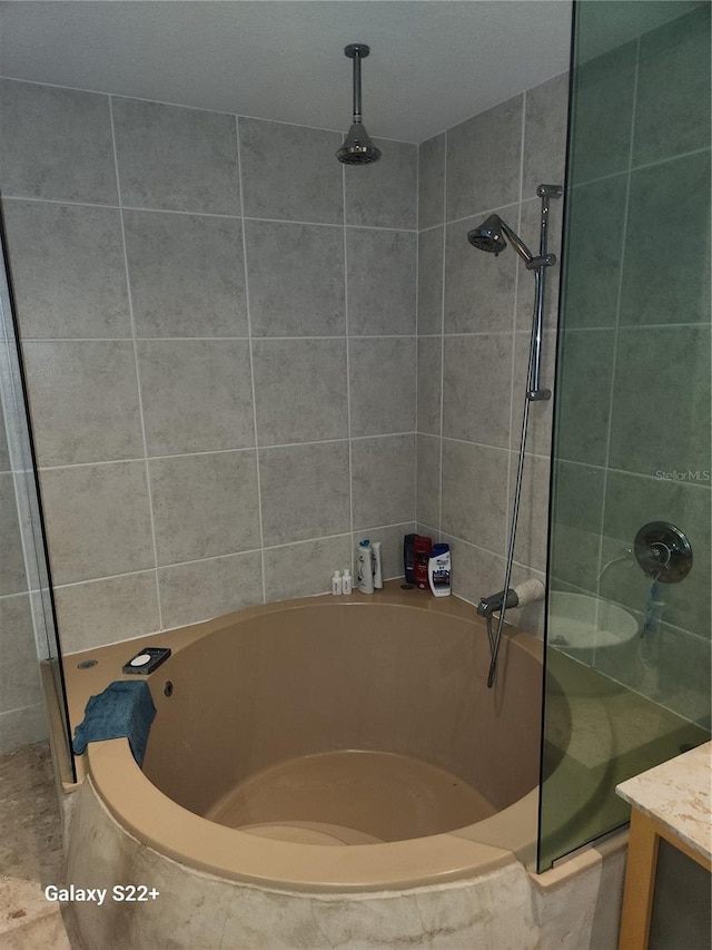 bathroom with shower with separate bathtub