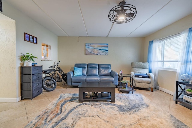 living room featuring ceiling fan and light tile patterned flooring