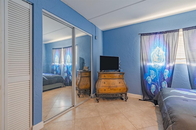 bedroom featuring a closet and light tile patterned floors