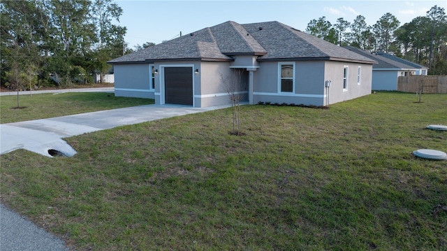 view of front of property with a front lawn and a garage