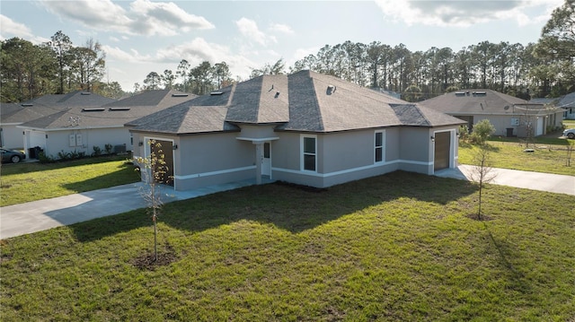 view of side of home featuring a yard and a garage