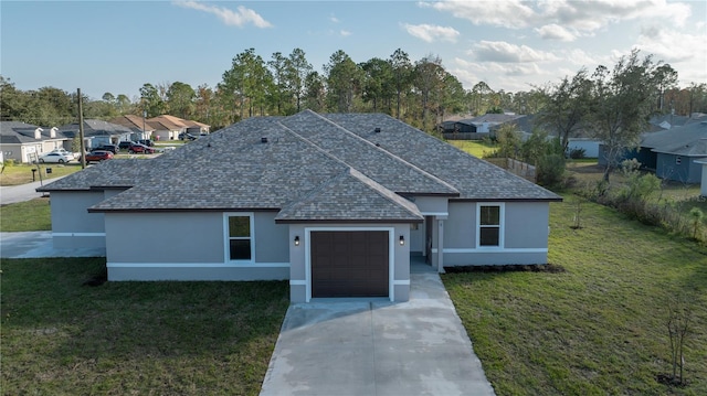 ranch-style house featuring a garage and a front lawn