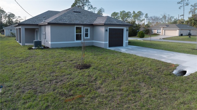 view of home's exterior with a lawn, cooling unit, and a garage