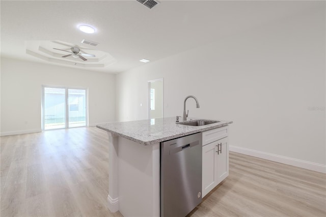 kitchen featuring a kitchen island with sink, sink, stainless steel dishwasher, a tray ceiling, and white cabinetry