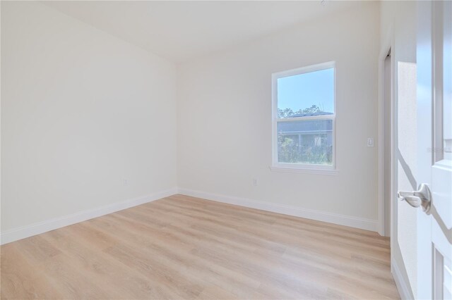 empty room with light hardwood / wood-style flooring