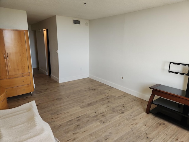 935 N Halifax Ave Unit 602, Daytona Beach, FL 32118 - unfurnished bedroom featuring visible vents, baseboards, and wood finished floors
