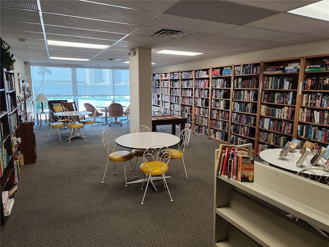 935 N Halifax Ave Unit 602, Daytona Beach, FL 32118 - interior space featuring carpet floors, wall of books, visible vents, and a paneled ceiling