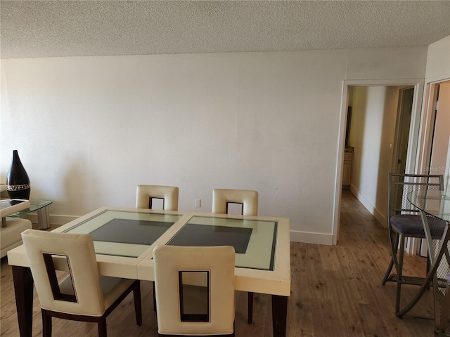 935 N Halifax Ave Unit 602, Daytona Beach, FL 32118 - dining area with baseboards, a textured ceiling, and wood finished floors