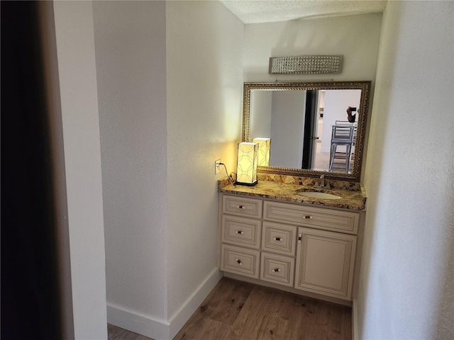 935 N Halifax Ave Unit 602, Daytona Beach, FL 32118 - bathroom with baseboards, wood finished floors, and vanity