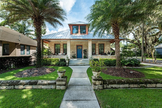 view of front of home with a porch and a front lawn